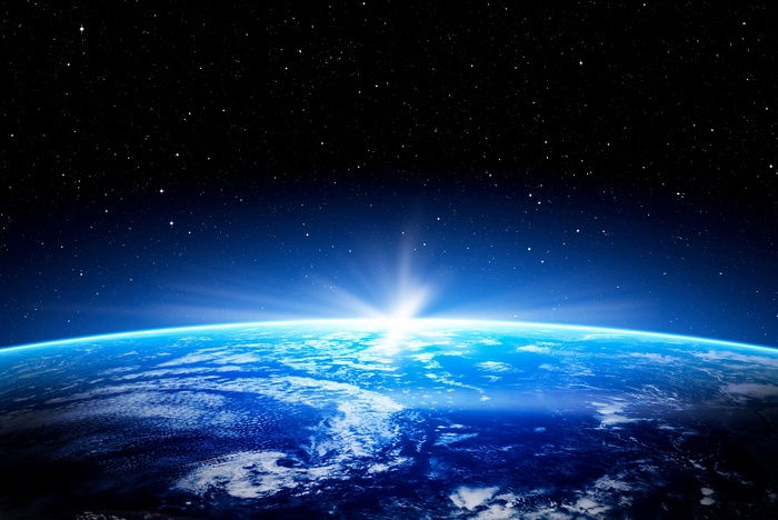Earth from space with sunrise and stars