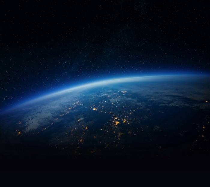Earth from space with city lights and stars