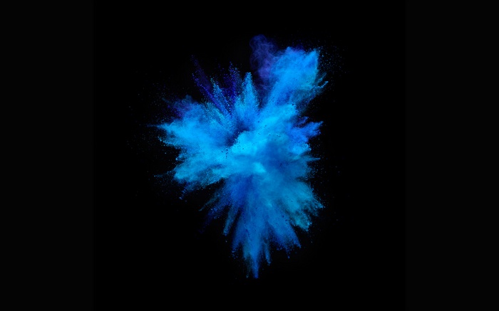 Blue powder explosion on black background