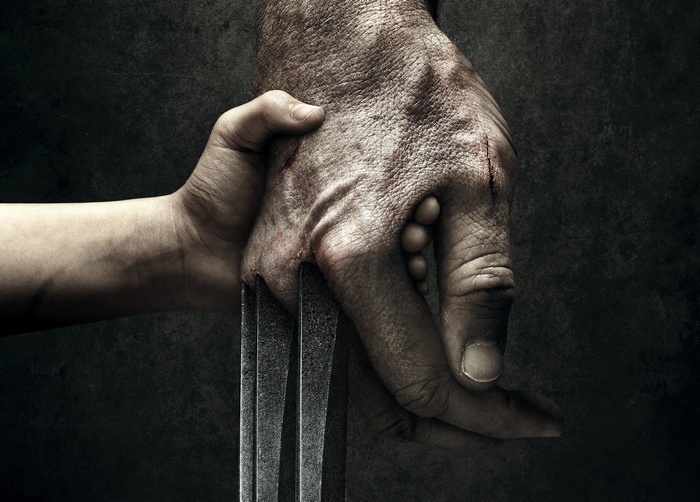 Logan holding a child's hand with claws
