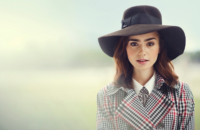 Lily Collins wearing a hat and trench coat