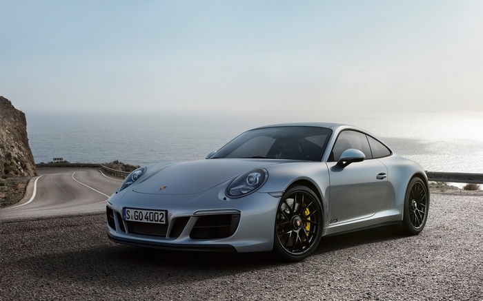 Silver Porsche 911 Carrera 4 GTS on a Coastal Road