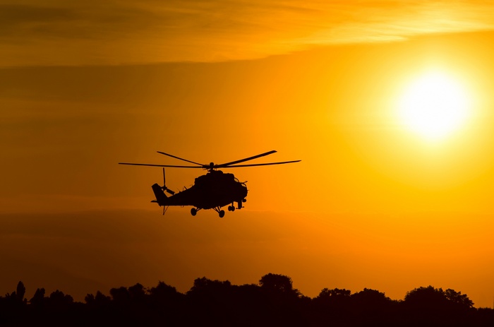 Silhouette of a Mil Mi-2 helicopter at sunset