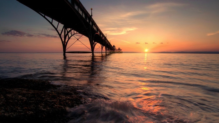 Pier over the ocean at sunset