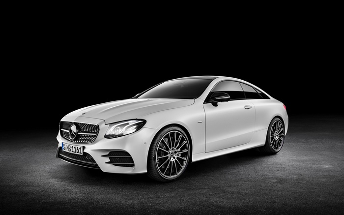 White Mercedes-Benz E-Class Coupe on a dark background