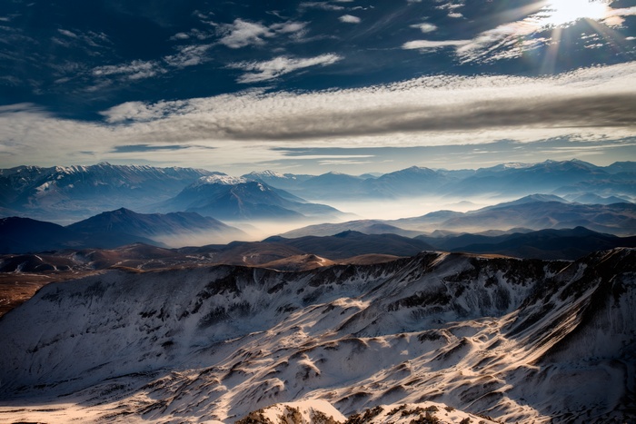 Snow-capped mountains under a sunny sky