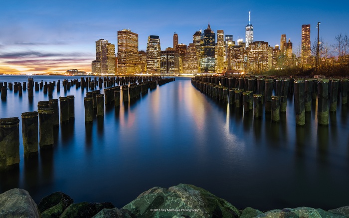 New York City skyline with pier pilings at dusk