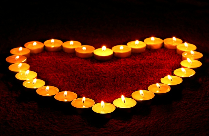 Heart shape made of lit candles