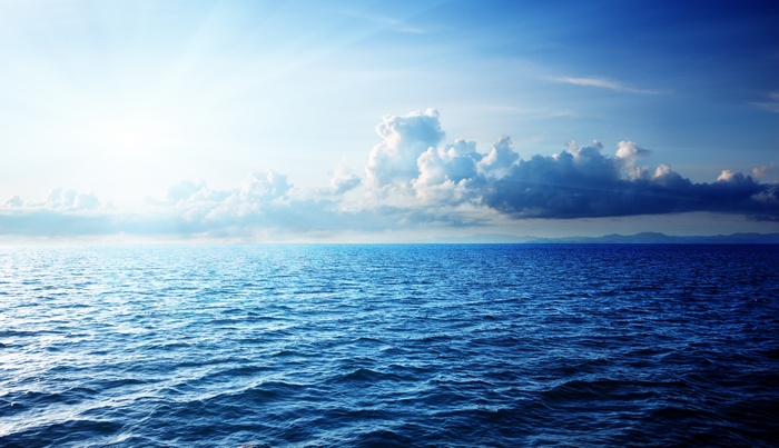 Ocean horizon with clouds and sunlight