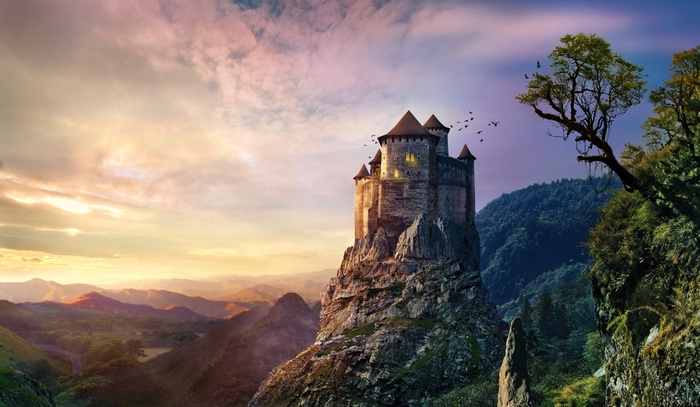 Castle on a rocky mountain at sunset