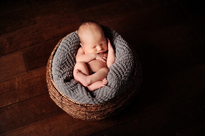 Newborn baby sleeping in a basket