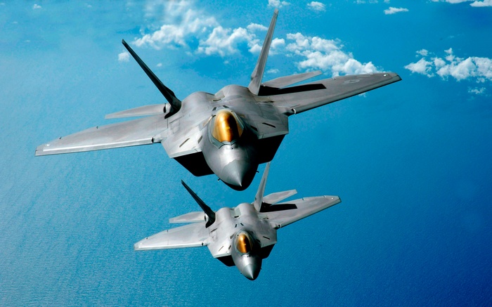 Two Lockheed Martin F-22 Raptors flying in the sky
