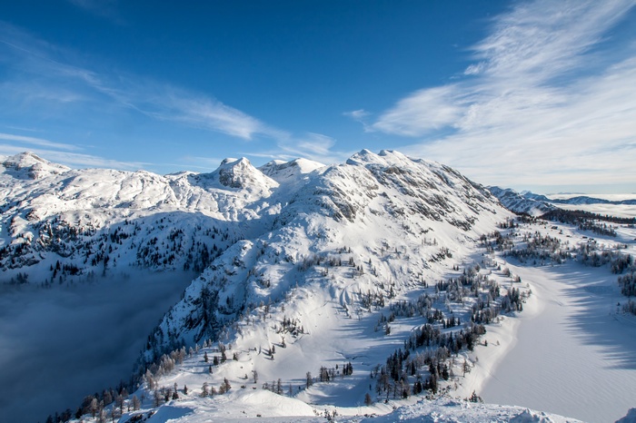 Snow-covered Alps mountains in winter under a blue sky