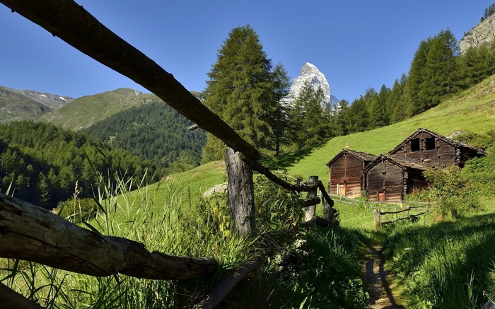 Wooden cabins in the Swiss Alps with Matterhorn mountain