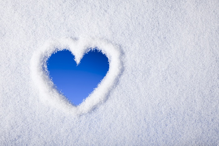 Heart shape in snow with blue sky