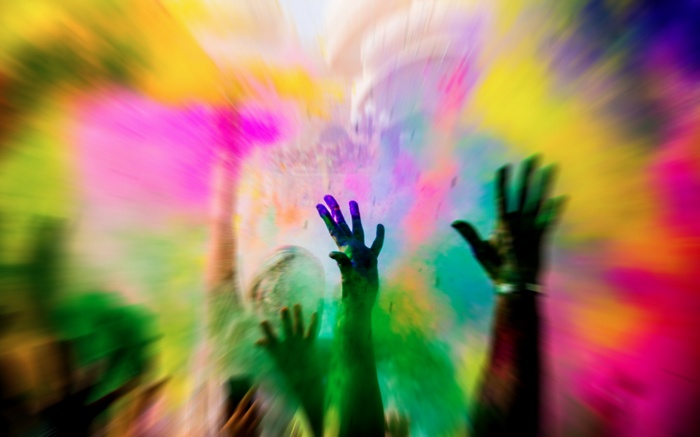 People celebrating Holi with colored powder