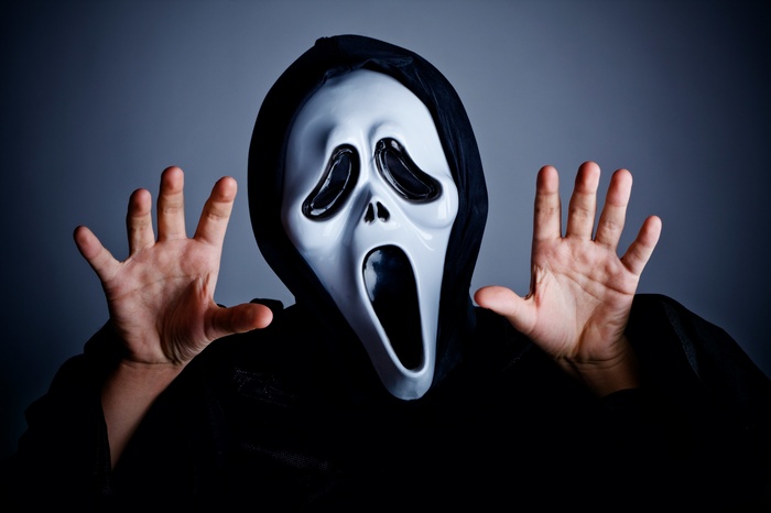 Person wearing a Scream mask