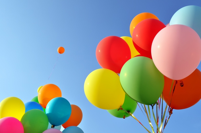 Colorful Balloons Floating in a Clear Sky