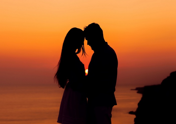 Couple embracing at sunset