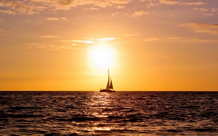 Sailboat on the ocean at sunset 4K