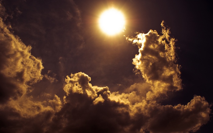 Sun shining through dark clouds