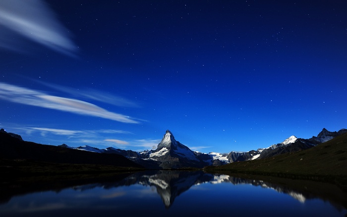 Matterhorn mountain reflected in a lake at night