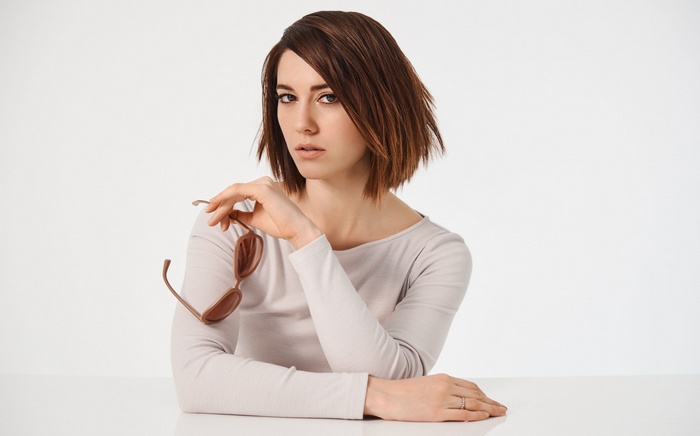Mary Elizabeth Winstead holding sunglasses