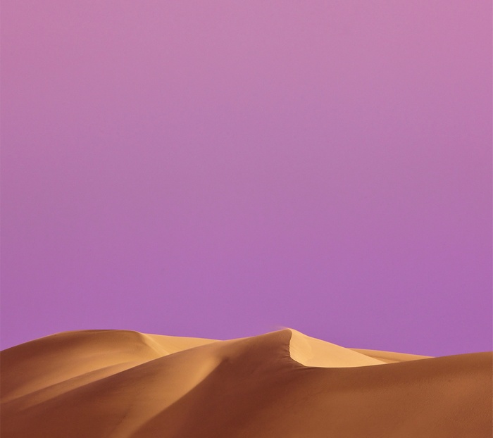 Sand dunes under a purple sky
