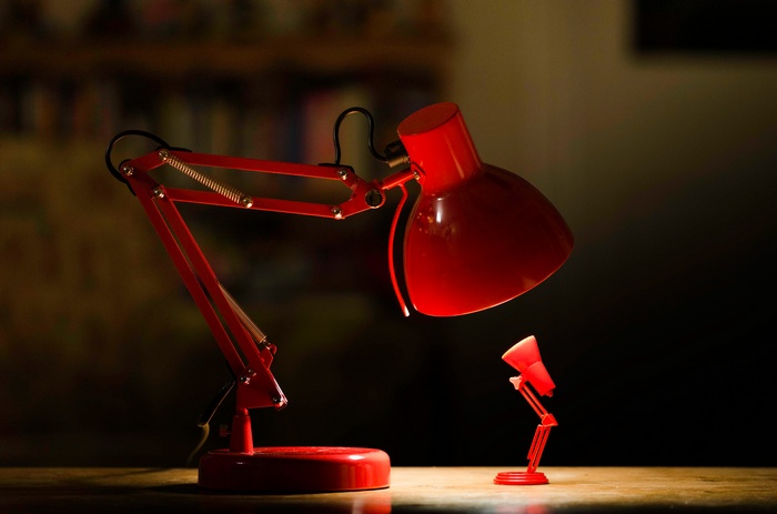 Two red desk lamps, one large and one small