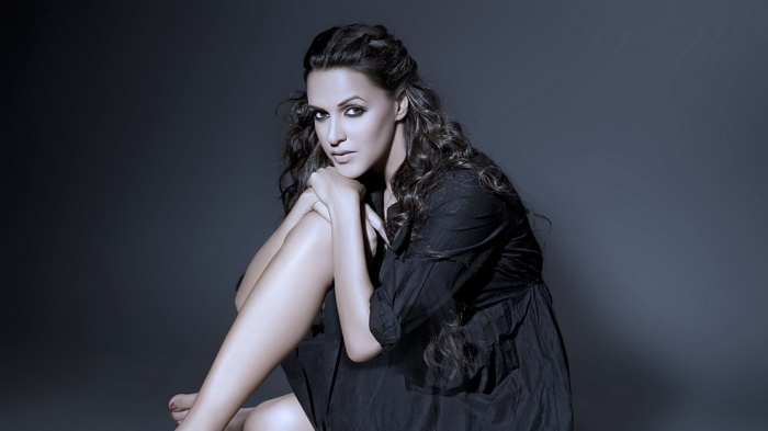 Actress Neha Dhupia sitting on floor