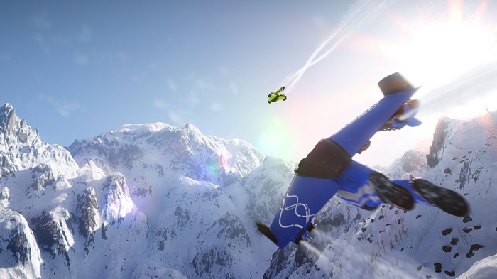 Wingsuit flyer and jetpack flyer over snowy mountains