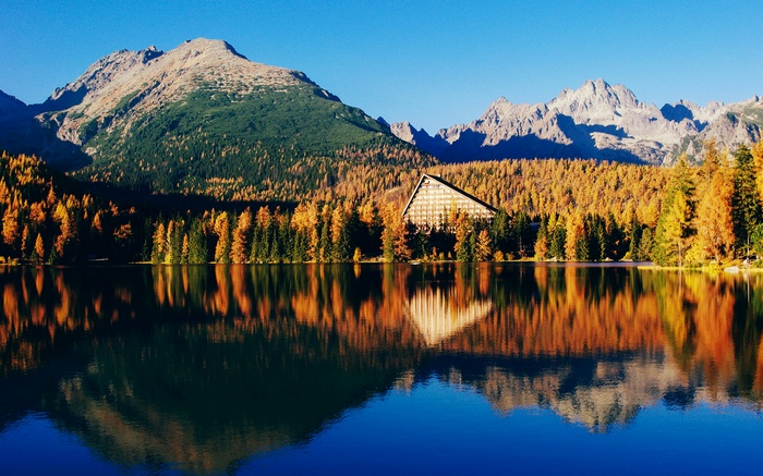 Mountain lake with autumn trees and hotel