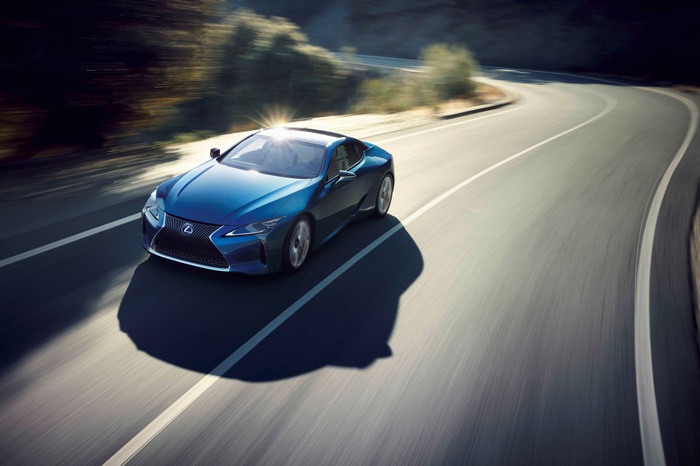 Blue Lexus LC500h Coupe on a Winding Road