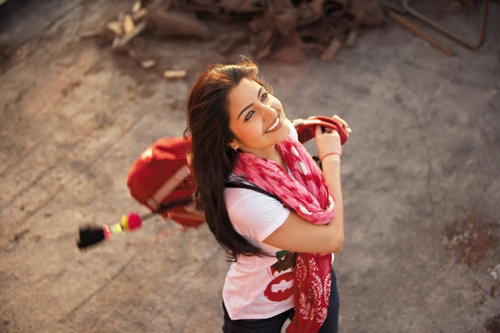 Anushka Sharma smiling with a red scarf