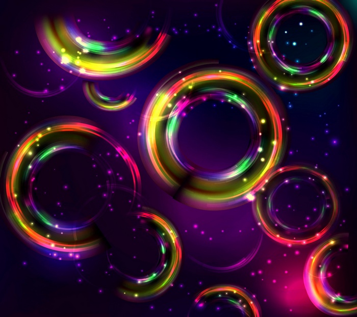 Colorful glowing rings and sparkles on dark background