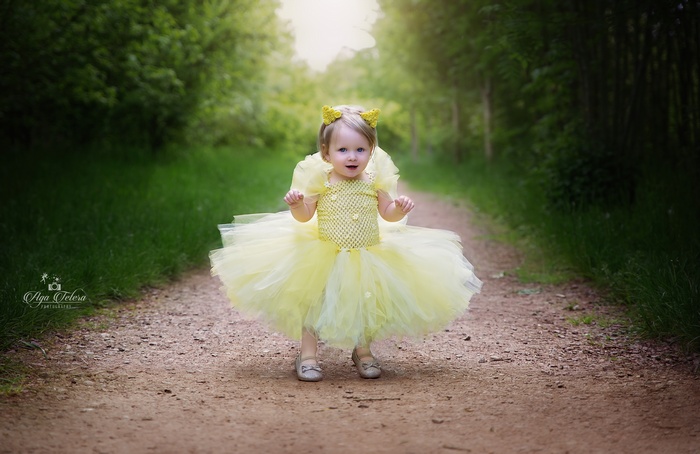 Cute baby girl in yellow tutu dress