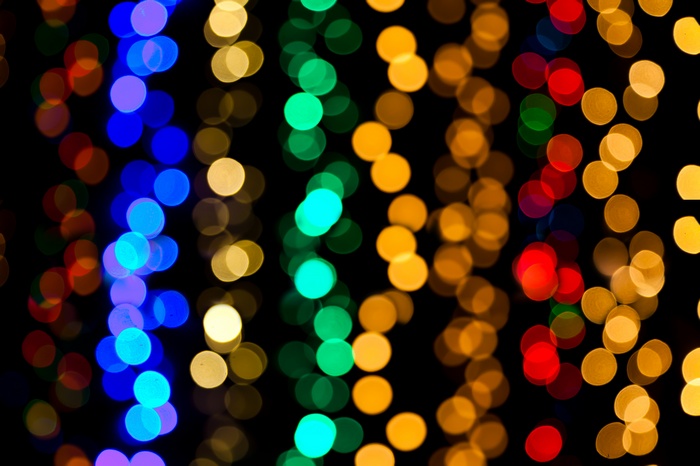 Bokeh blurred colorful lights on black background