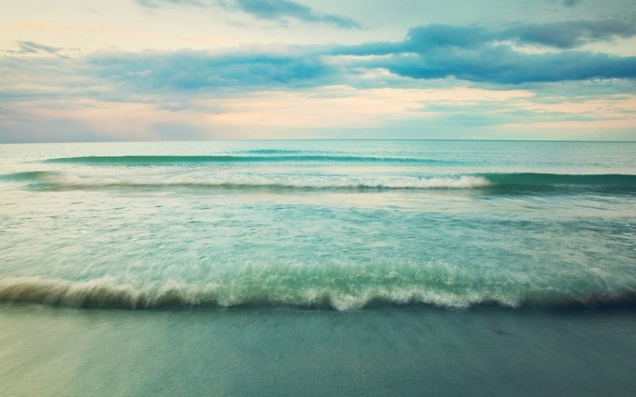 Ocean waves and cloudy sky