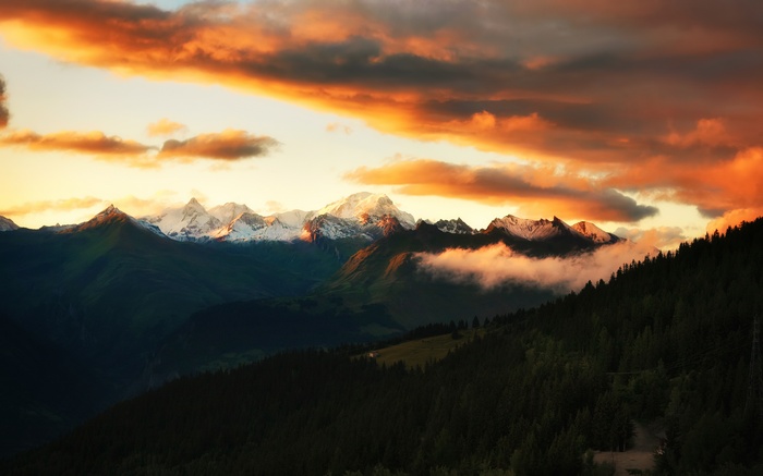 Sunset over snow-capped mountains in the French Alps