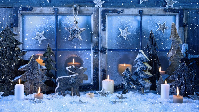 Christmas window decoration with candles and snow