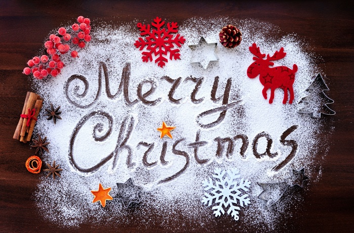 Merry Christmas written in powdered sugar with decorations