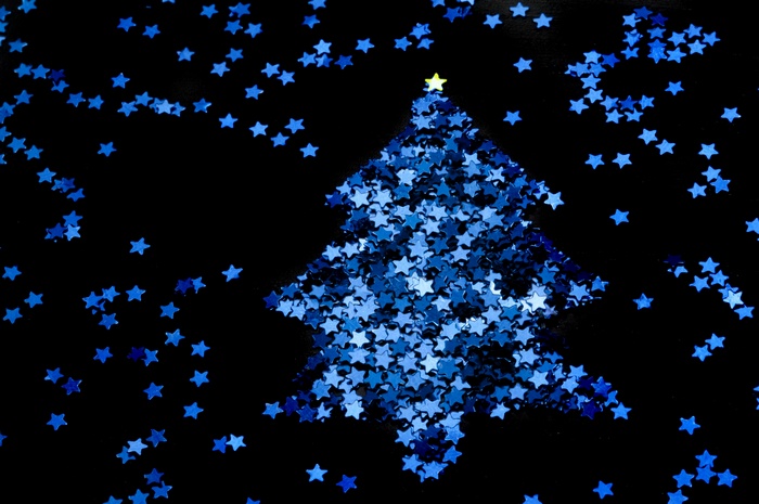 Christmas tree made of blue stars on black background