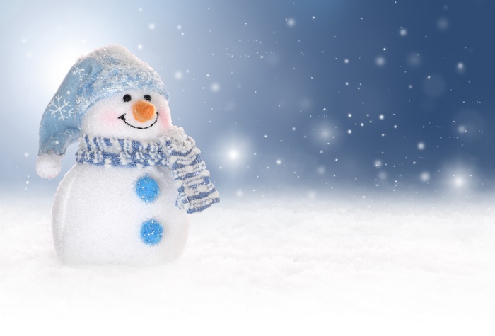 Snowman with blue hat and scarf in snow
