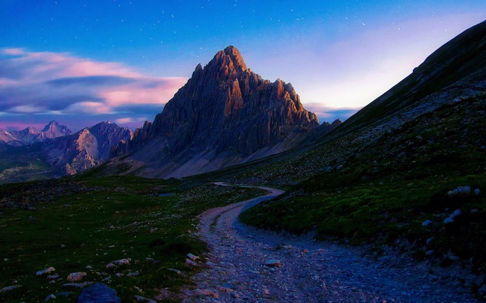 Mountain landscape with a winding path at dusk
