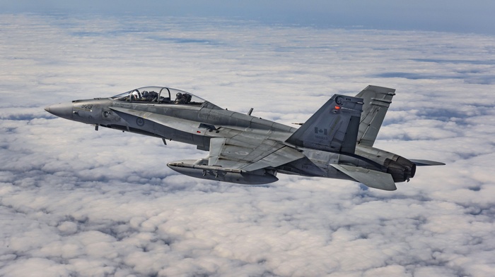 Royal Canadian Air Force CF-18 Hornet flying above clouds