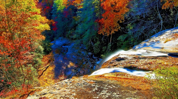 Waterfall in autumn forest with colorful foliage