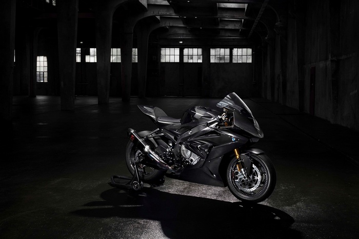 BMW HP4 Race motorcycle in a dark warehouse