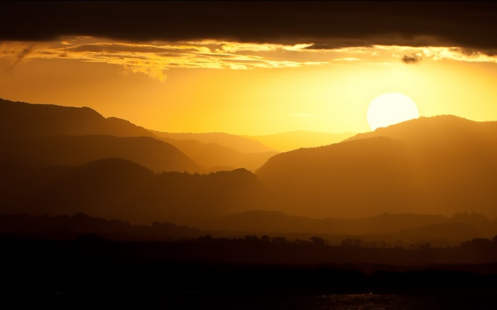 Sunset over layered mountains in Byron Bay