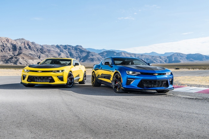 Yellow and Blue Chevrolet Camaros on a Racetrack