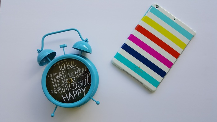 Blue alarm clock with quote and colorful iPad case